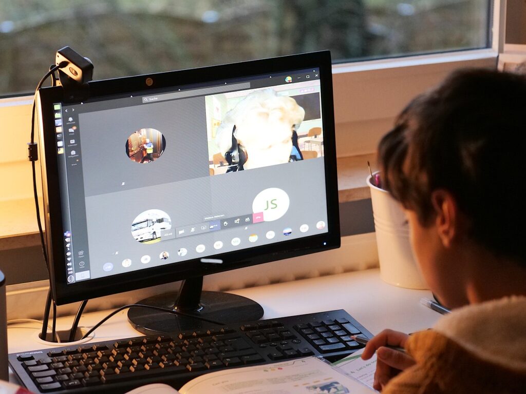 child doing schoolwork on computer online